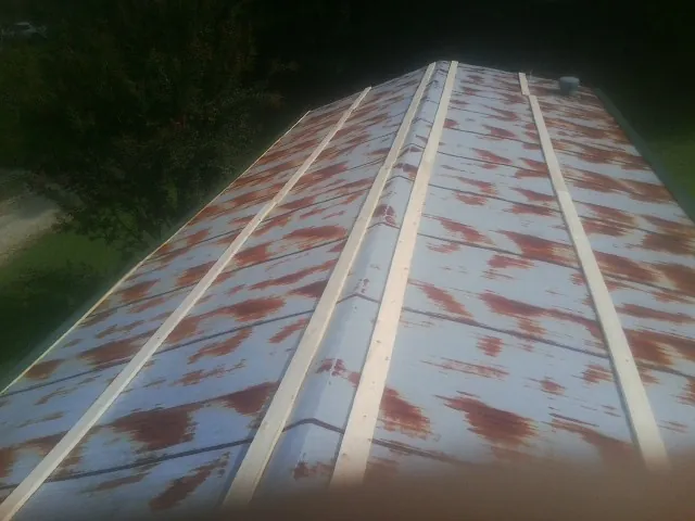 Rusted metal roof panels with new wood purlins before replacement — Storm Damage Roof Repair in Paulsboro by Roofing Brothers